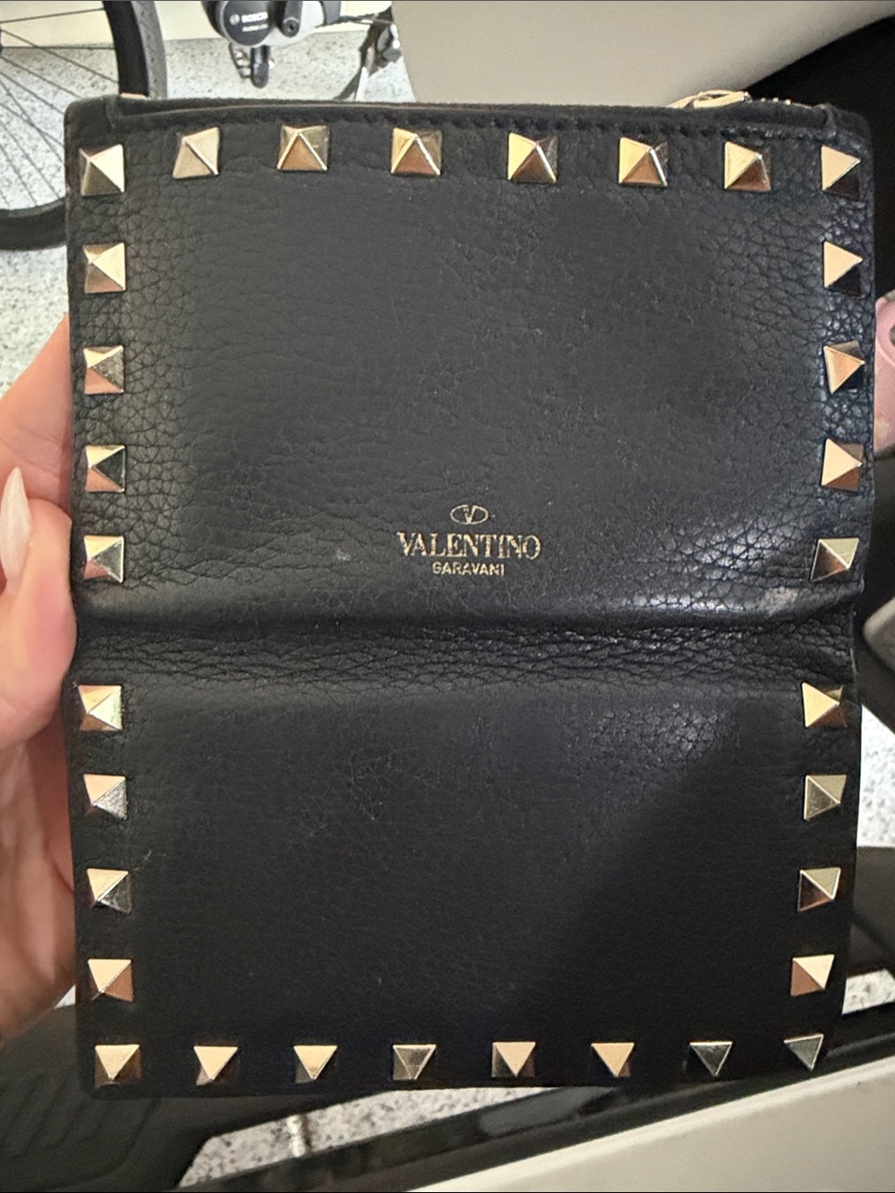 Valentino Garavani Black Leather Rockstud Wallet with Gold Studs folds in half